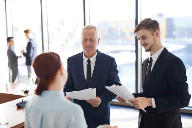senior-businessman-talking-to-employees-2021-09-24-04-04-48-utc-1
